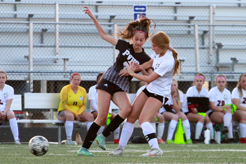 Sarah Cardillo of Brighton, right, and Prairie View's Cienna Rush fight for the possesion of the ball during their league match. Brighton defeated Prairie View 2-1 April 26.