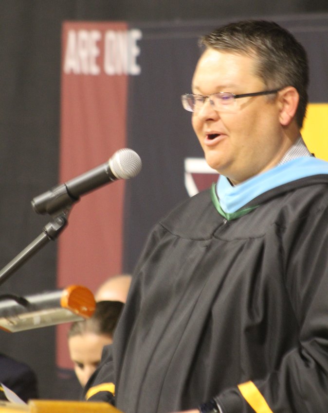 Eagle Ridge Academy's head of school, Scott Richardson, applauds the class of 2022 for its collective accomplishments during the school's commencement program at the University of Northern Colorado May 18.