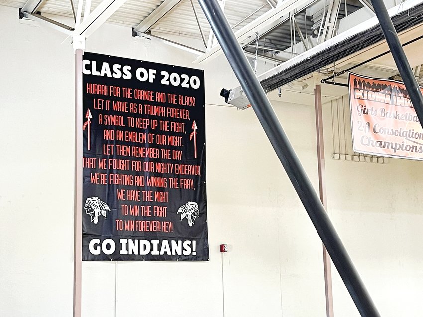 The Kiowa Schools’ fight song with the phrase “Go Indians” is on a large banner in the gym.