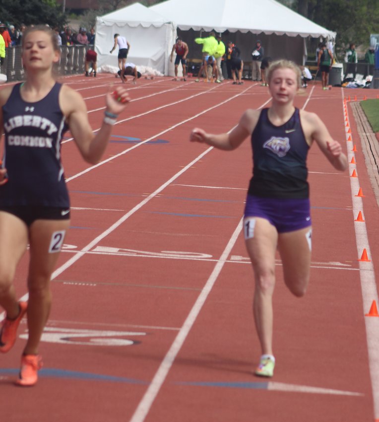 Holy Family's Skylar Hawk, right, wraps up her ninth-place finish in the girls 100-meters at the state 3A track meet in Lakewood on May 22. She also won two state titles.