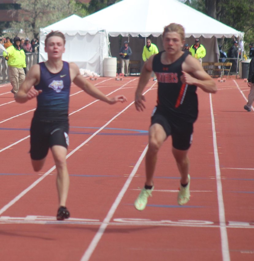 Holy Family's Grayson Arnold, left, lunges for the finish line at the end of the 100-meter dash at the state track meet May 22 in Lakewood. He finished second, and he also took second in the 200-meter dash.
