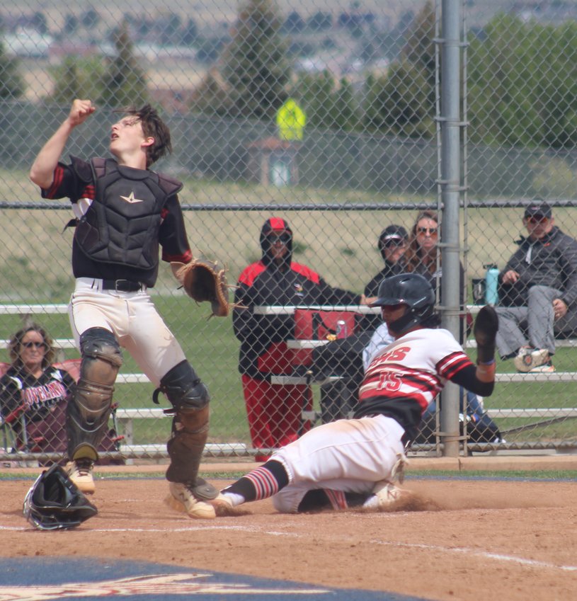 Brighton's Isaac Rodriguez scores a run as Loveland's Carter Leben tries to track down an errant throw during a regional playoff game in Parker on May 23.