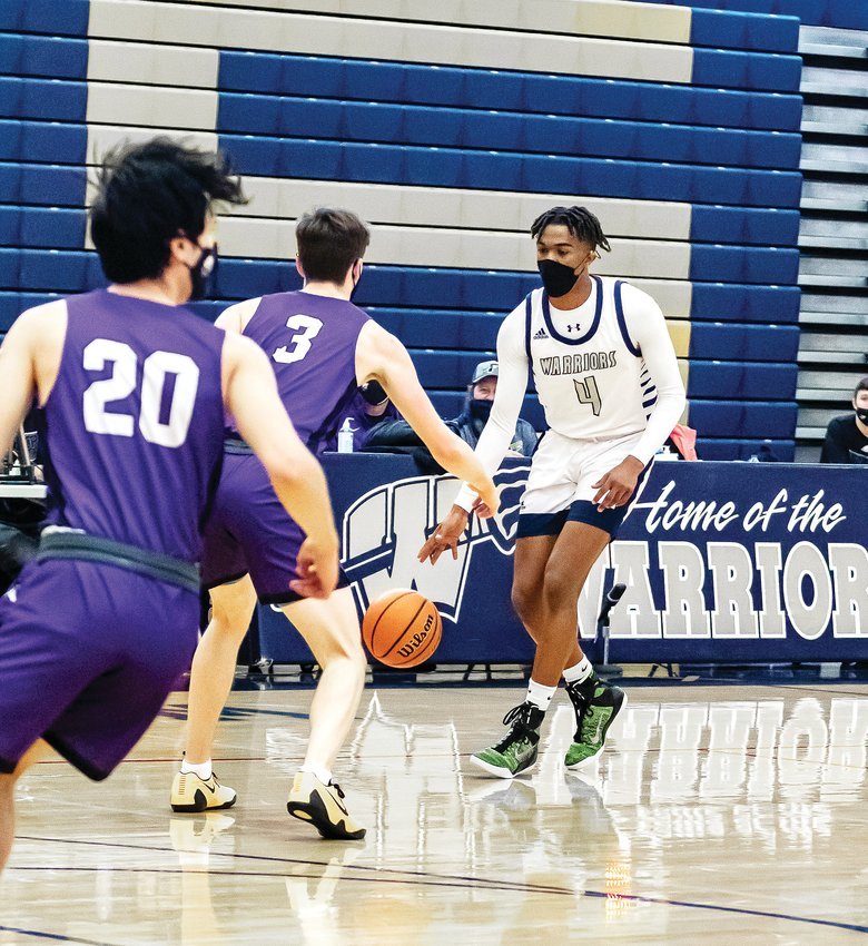 Frederick’s Izayah Elize faces off against two players from Mountain View March 2021 photo.