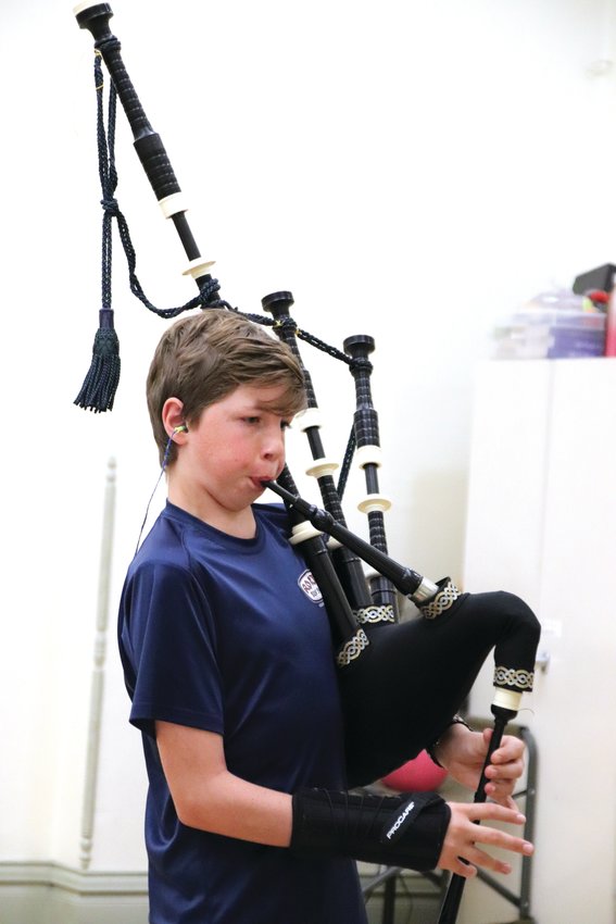 Aiden Palmer plays the bagpipes during a Colorado Youth Pipe Band rehearsal in June. The pipe band practices year-round at the Washington Street Community Center and welcomes youth from across the Front Range.