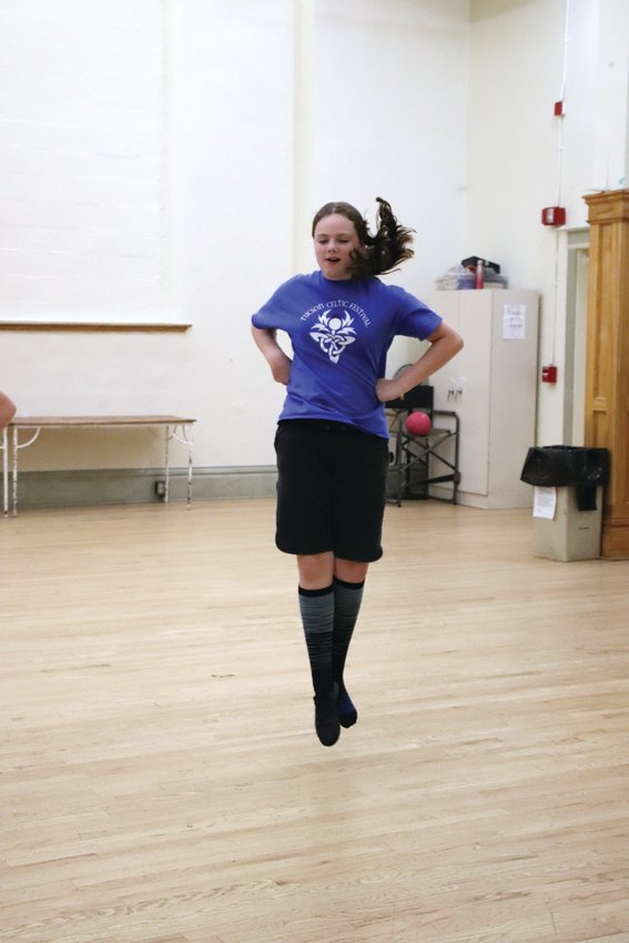 Cora Delaney practices a jump for a Highland dance routine.