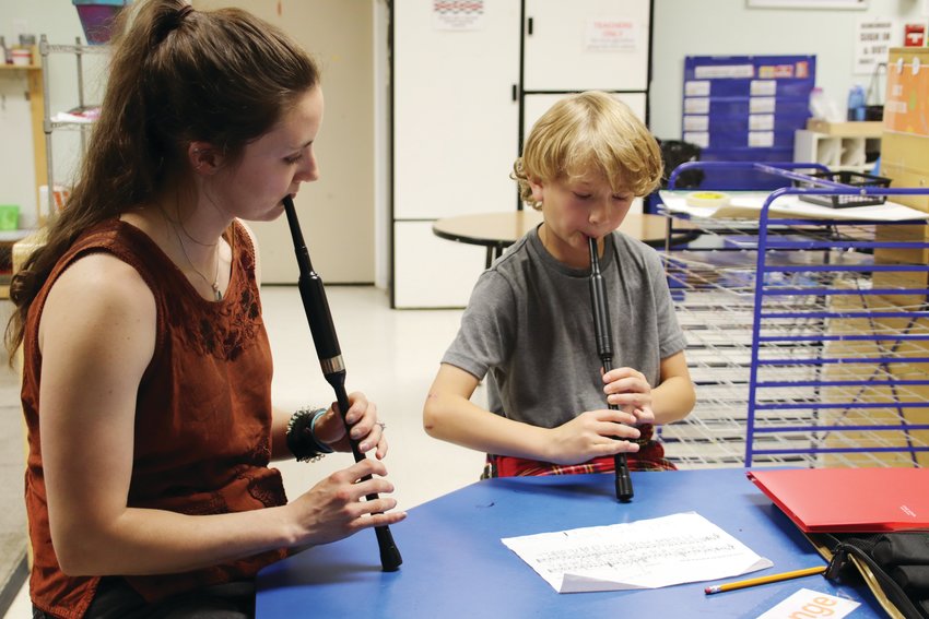 Ana Fairbanks-Mahnke, a piping instructor with the Colorado Youth Pipe Band, works with chanter student Kavyn Jenkins.