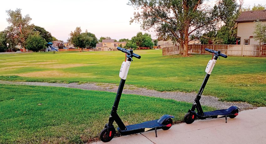 A pair of Bird Scooters sits waiting for riders outside a neighborhood park just south of 128th Avenue in Thornton along Eudora Street.