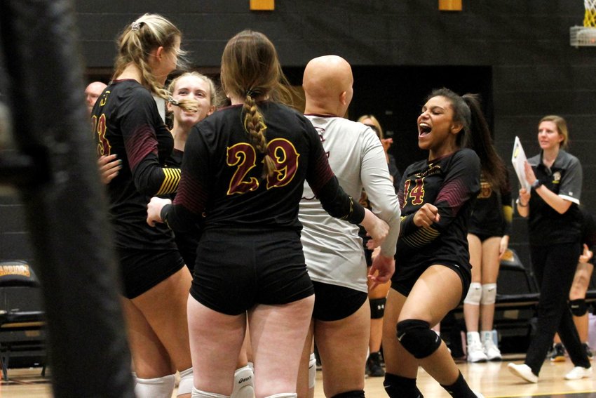The Warriors celebrate together as they manage to win the second set of the match against Fort Lupton Aug. 30 on Eagle Ridge's floor. Eagle Ridge Academy defeated Fort Lupton in four sets.