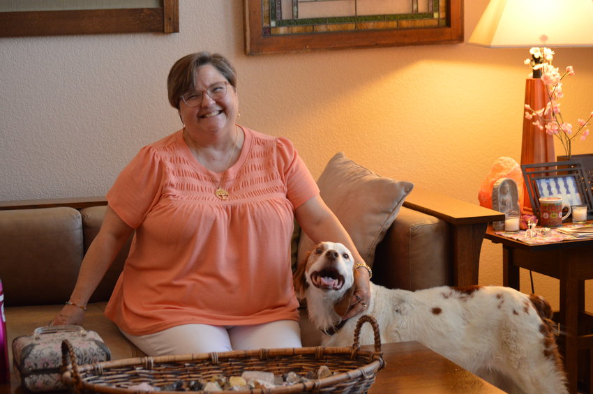 Vanessa Johnston, a death doula of five years, with her dog at her home in Highlands Ranch on Aug. 25, 2022.