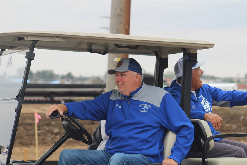 Weld Re-8 chief operations officer and Fort Lupton High School boys basketball coach Jim Roedel and FLHS wrestling coach Tom Galicia ride in one of the lead carts during the school's Sept. 9 homecoming parade.