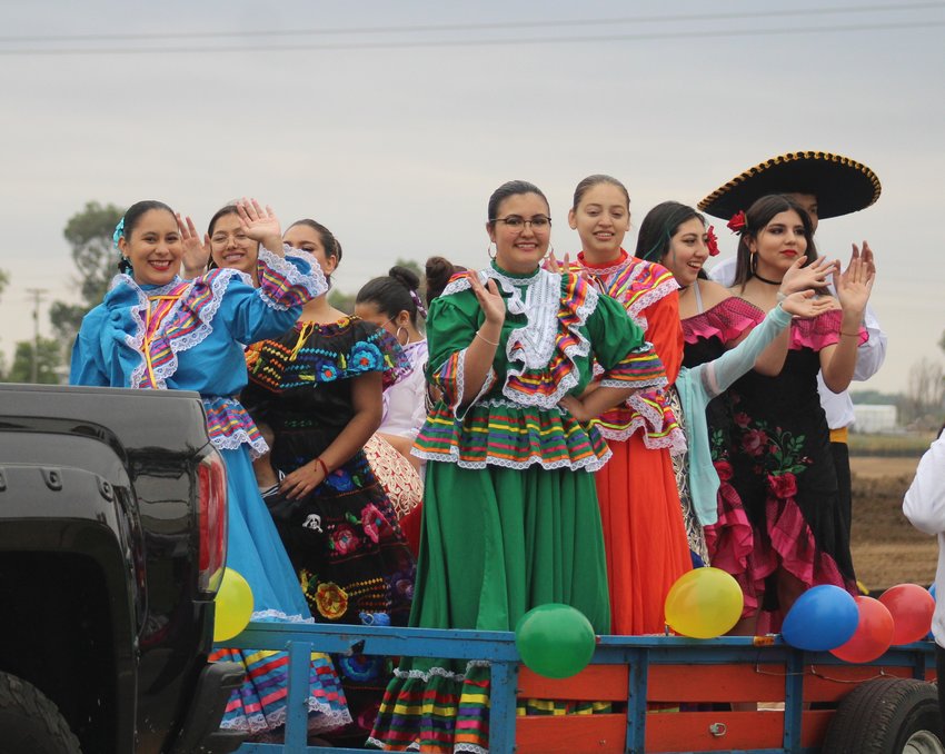 Members of Fort Lupton High School's Folklorico ride down the homecoming parade route Sept. 9.