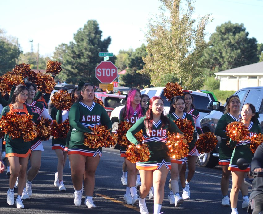 Adams City's cheerleading squad walks down the homecoming parade route Septe. 17.