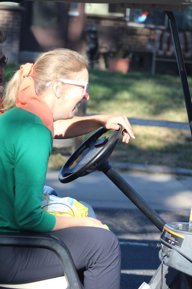 Adams City asssistant principal Amy Boisaubin gets a chuckle as she rides along the homecoming parade route Sept. 17.