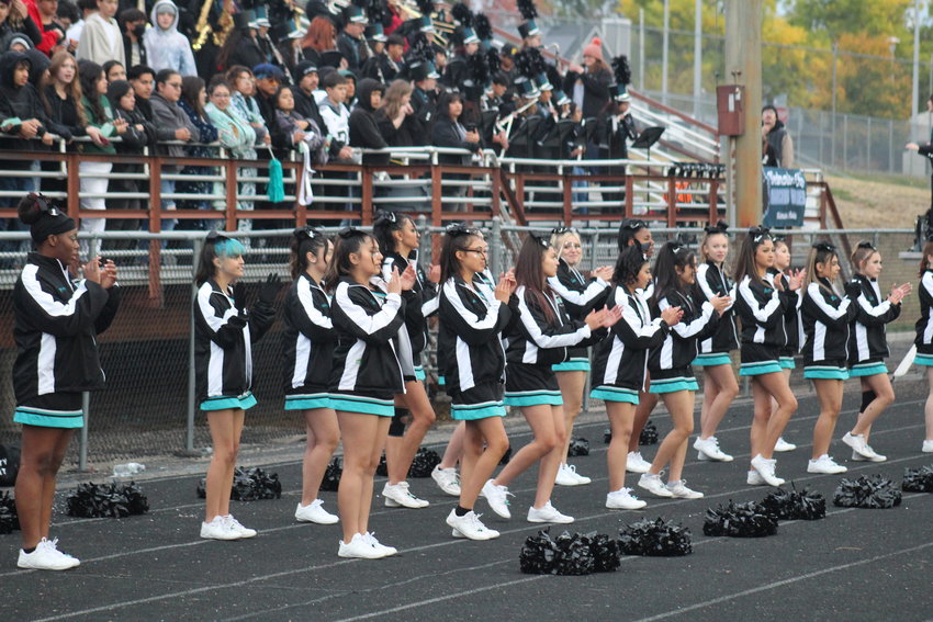 Westminster's football team gets some sideline help from the cheerleaders during the Wolves' homecoming game against Mountain Range Oct. 7.