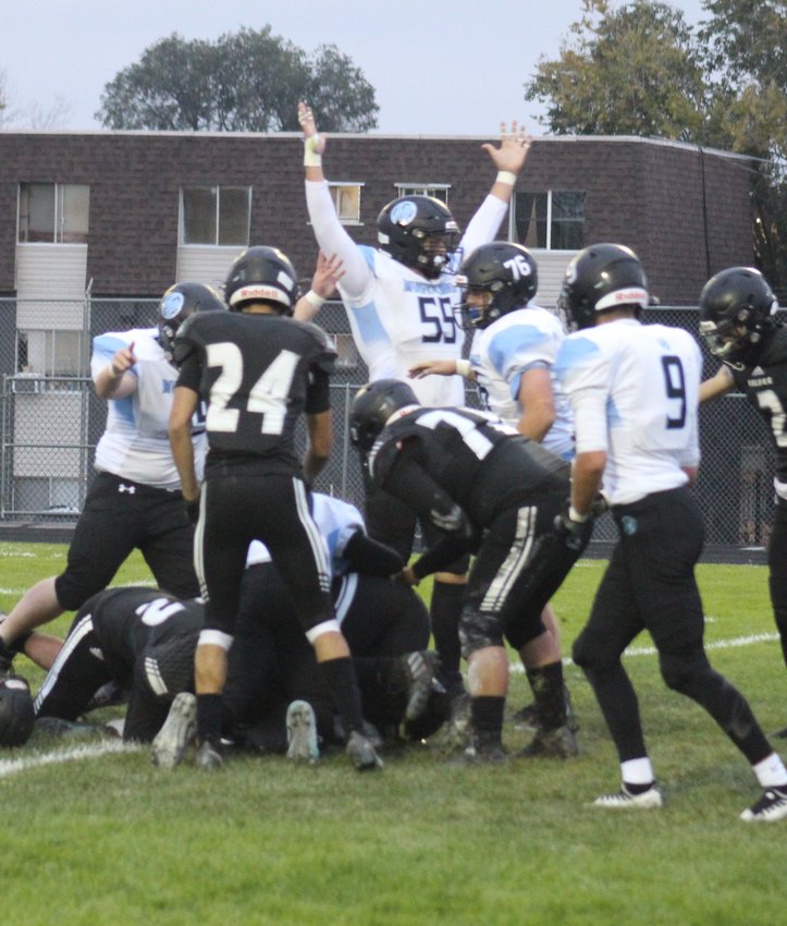 Amid a pile of bodies, Mountain Range's Chase Fanning celebrates his team's first touchdown against Westminster Oct. 7 during the Wolves' homecoming game.