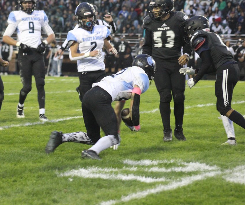 Mountain Range's Dylan Sherman regains his footing after a first-down gain during his team's game at Westminster Oct. 7.