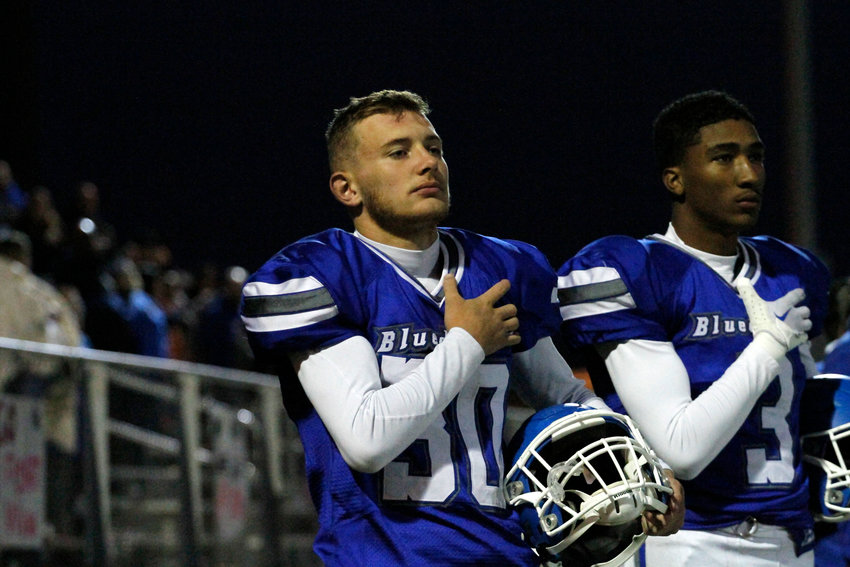 Fort Lupton's juniors Kaidyn Taylor (30) and Anthony Blan-Mendenhall (3) are focused during the national anthem prior to their Oct. 7 home league game against Eaton. Eaton beat Fort Lupton 52-6.