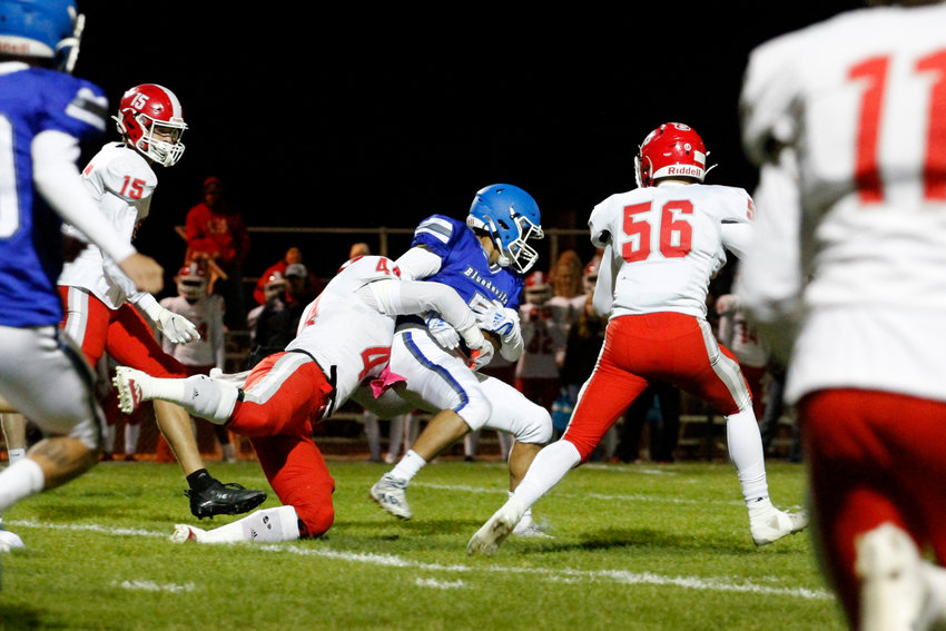 Eaton's Ryder True (44) is able to stop Fort Lupton's Joseph Gallegos (2) before rushing for a short gain. The Reds defeated the Bluedevils 52-6 in a league match played in Fort Lupton Oct. 7.
