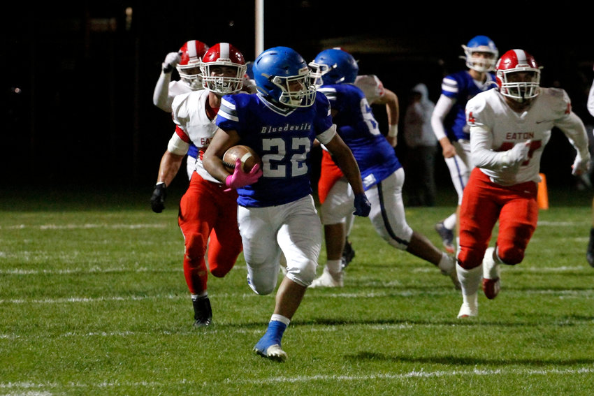 Antonio Gonzalez (22) is able to break free and rush in the open field as he is being chased down by the Reds' defense during their league home game Oct. 7 in Fort Lupton. Eaton defeated the Bluedevils 52-6.
