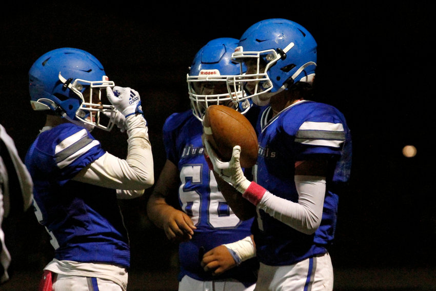 Danny Rodriguez (1) celebrates his touchdown catch with his Fort Lupton teammates during their home league match against Eaton. The touchdown was not enough for the Bluedevils as they lost to the Reds 52-6.