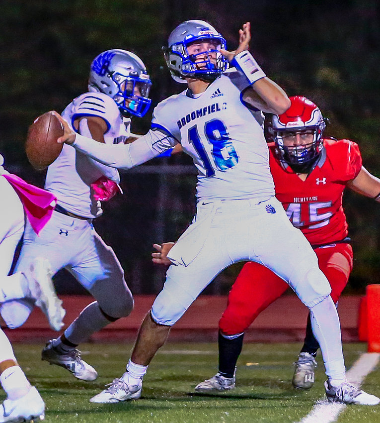 Broomfield quarterback Cole Lacrue launches this pass downfield against the onrushing defense of Heritage's Lucas Madrid Oct. 28.