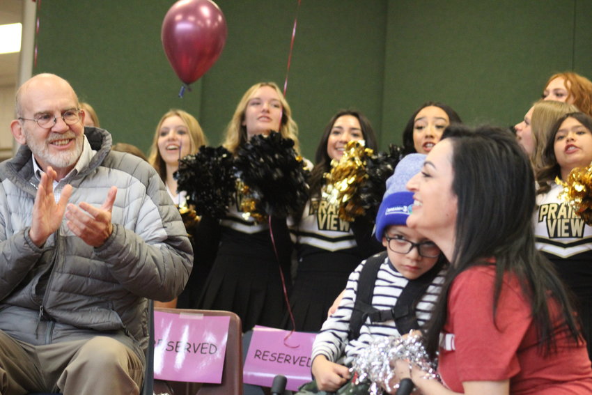 27J School board member Tom Green, far left, and cheerleaders from Prairie View High School lead the applause for 7-year-old Dorian Hernandez during a send-off event at Thimmig Elementary School Nov. 3.