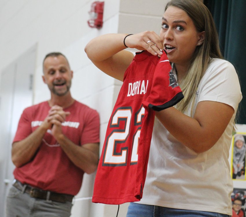 Dream on 3 representative Noelle Colligan is about to give 7-year-old Dorian Hernandez his own Tampa Bay Bucs jersey at Thimmig Elementary School Nov. 3.