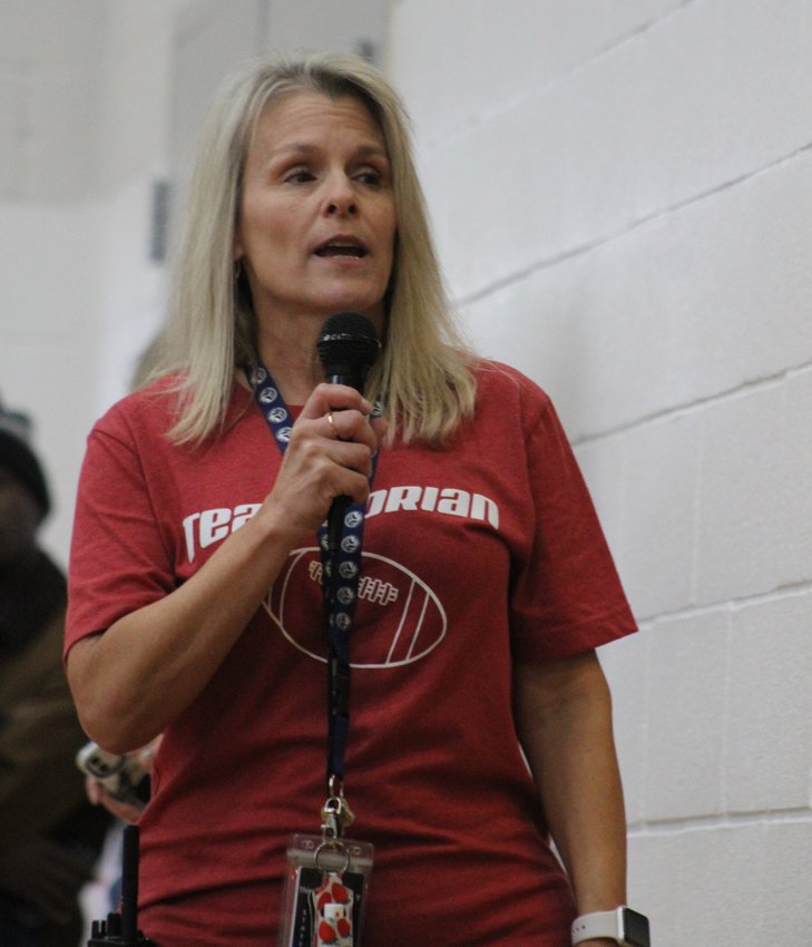 Cindy Ritter, the principal at Thimmig Elementary school, emcees a send-off program for second-grader Dorian Hernandez Nov. 3. Hernandez went to Tampa Bay, Florida, to see his favorite NFL team and his favorite player.