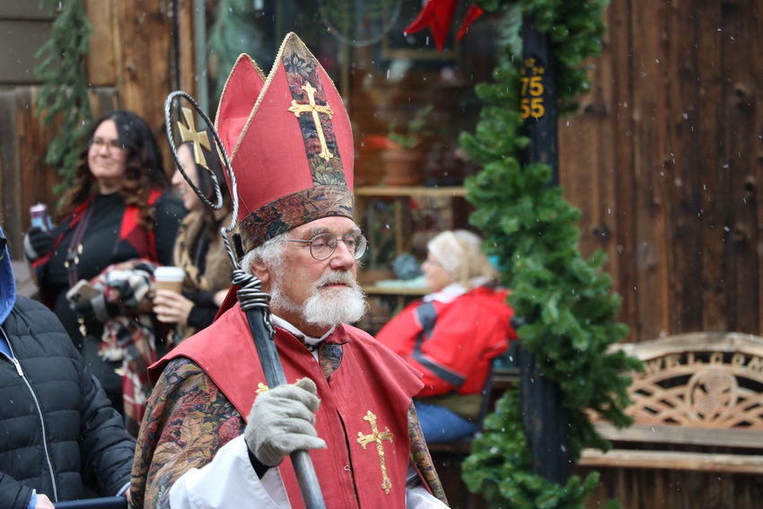 St. Nicholas in traditional garb leads the children's procession.