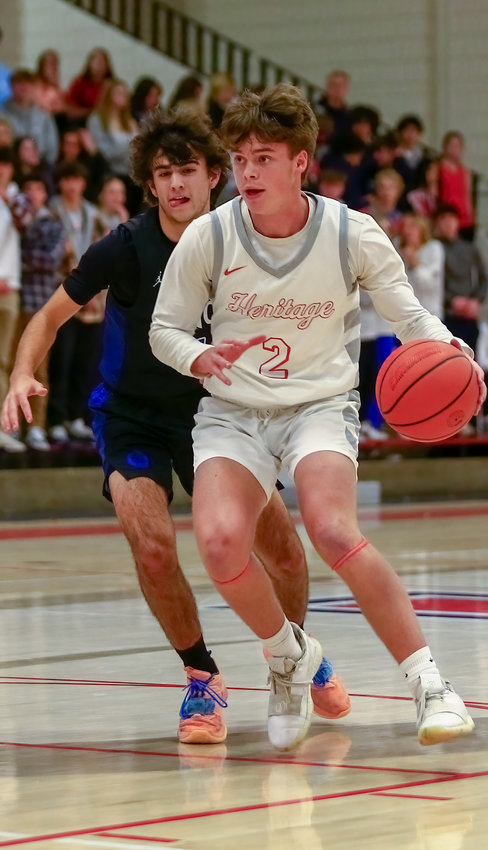 Heritage's Henry Hossfeld moves up the floor during a game against Highlands Ranch Jan. 2.
