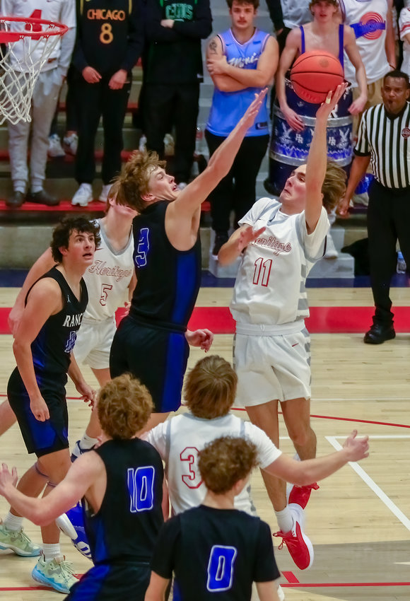 Hank Gorzelanski of Heritage opts for the hook shot against Payton Tereick of Highlands Ranch during the teams' Continental League game Jan. 20.
