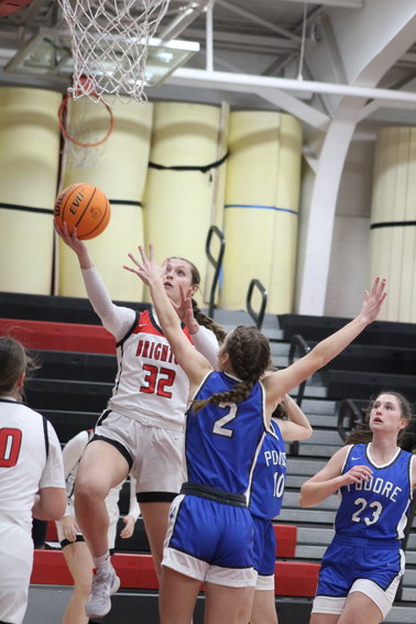 Amanda Byrnes of Brighton High School sails in for a first-half layup attempt against Jaqui Wilson of Poudre during a Northern League game Jan. 24 in Brighton.