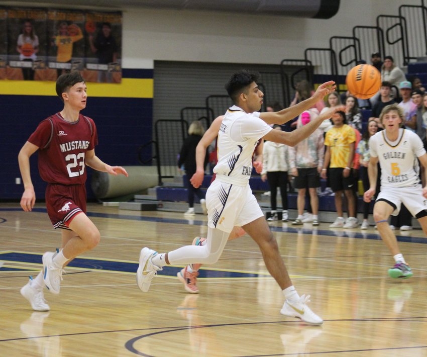 Harry Singh of the Golden Eagles leads the fast break against Fort Morgan's Forrest Jordan during a Jan. 26 game in Frederick. Singh's teammate is Jacob Lovins (5).