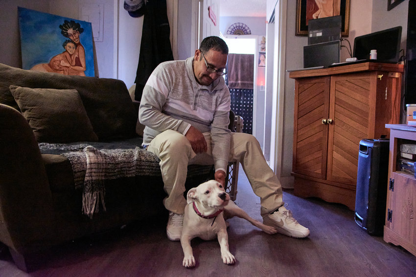 David Hernandez pays government-subsidized rent for his one-bedroom apartment, where he lives with his dog, Dojah.