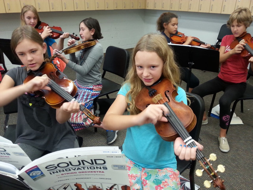 Students play the donated instruments they received through a previous Bringing Music to Life Instrument Drive.