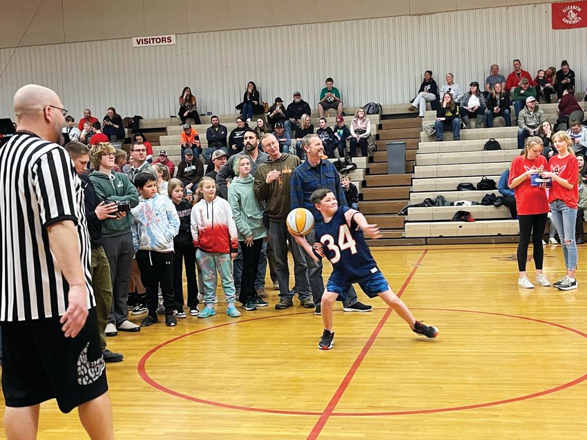 An attendee at the unified basketball game attempts a half-court shot in a bid to win $25 at halftime.