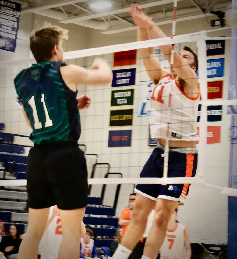 Legend's Timothy Gibbs (11) blocks an attempted spike by ThunderRidge's Westley Watson (11) during the match on March 23 at Legend.