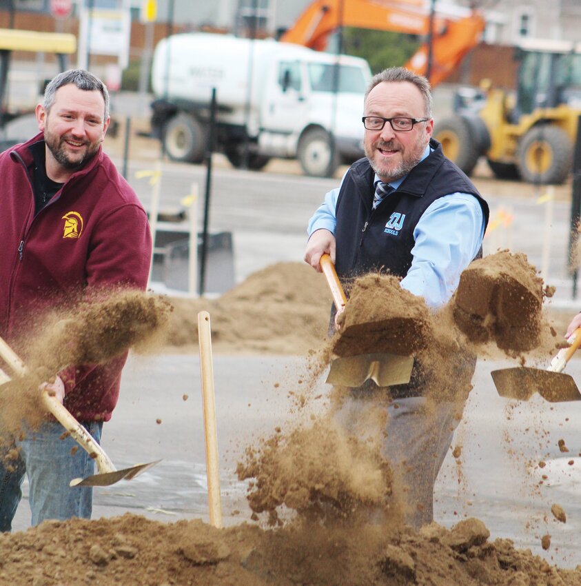 Eagle Ridge Academy Athletic Director Zach Henning, left, and 27J Schools Superintendent Chris Fiedler turn the shovels during the christening of the school's new on-campus soccer stadium March 31.