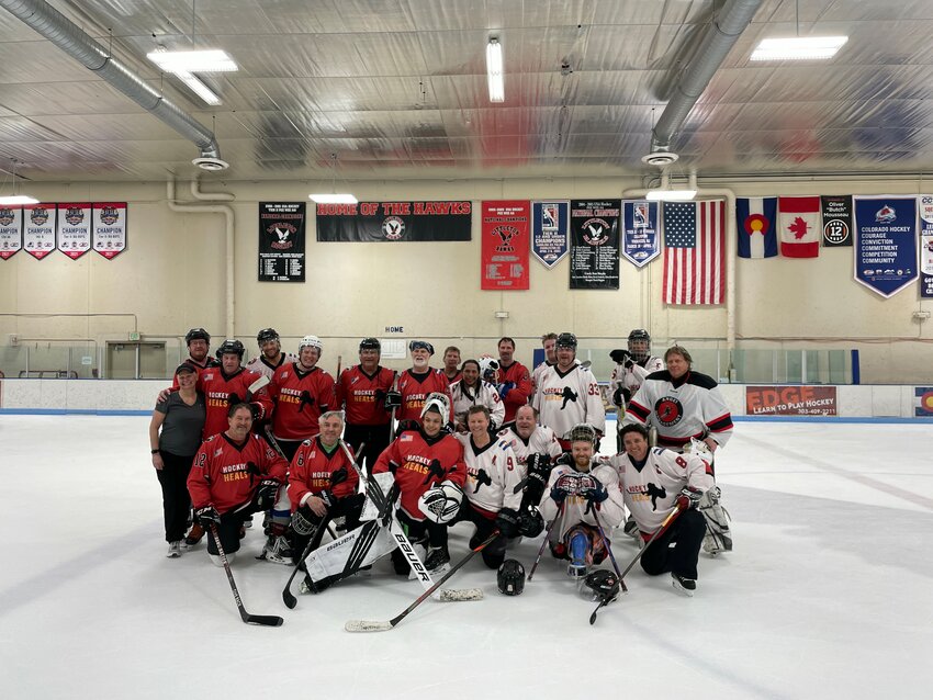 Members of the Dawg Nation Hockey Heals group pose for a team photo on the ice at Edge Ice Arena on March 8.