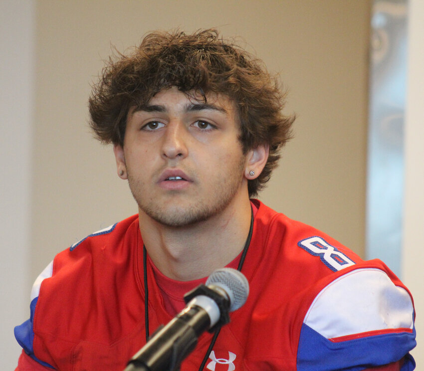 Cherry Creek's Angelo Petrides speaks at the podium at CHSAA's Media Day at Empower Field on Aug. 14. He said he is for college realignment.