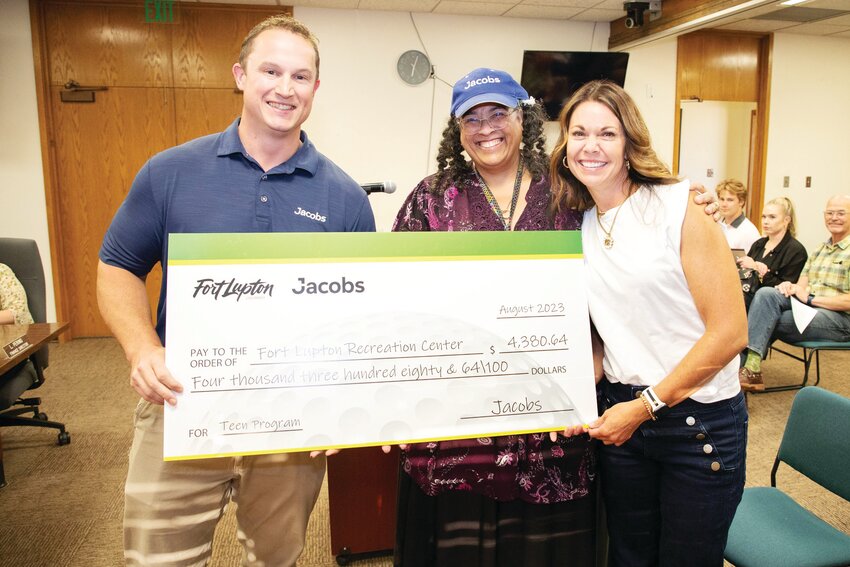 Aaron Richardson, Stephanie Mays, and Julie Holm, Recreation Center assistant recreation director, with a $4,380.64 check.