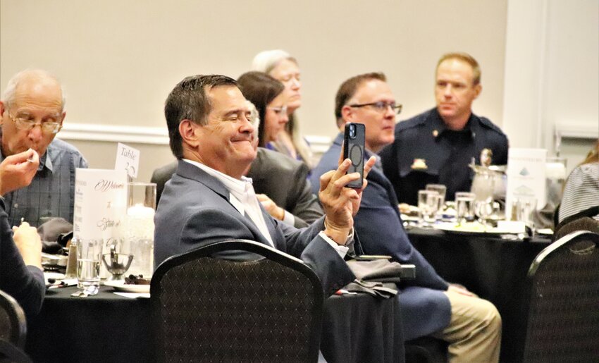 City Councilor Mark Freitag snaps a photo of Mayor Nancy McNally and City Manager Mark Freitag during the State of the City event Aug. 23 at the Double Tree Hotel.