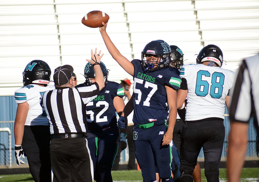 Standley Lake sophomore Nikko Blanco (57) raises the football after recovering a fumble on the opening offensive play of the game Thursday, Sept. 7, at the North Area Athletic Complex. The Gators took a 34-29 victory over Westminster to improve Standley Lake's record to 2-1 on the season.