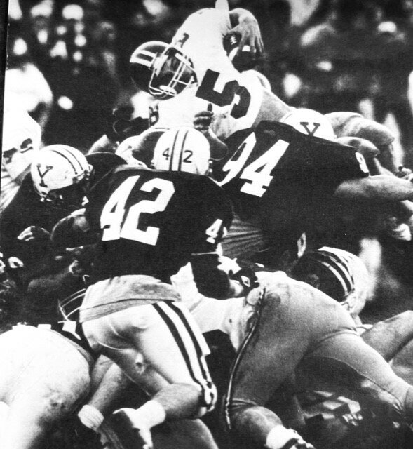 Nick Isaacson, the head football coach at Clear Creek High School, was an all-state running back for Milton High School in Wisconsin in 1989. Here he is seen running over the pile. Isaacson would play four years at Harvard after his high school career.