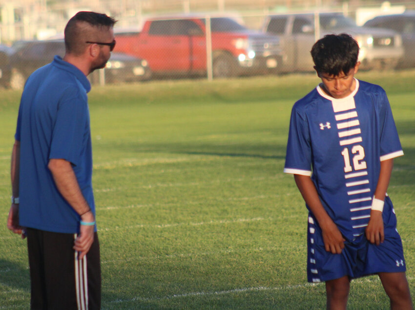 Archi Gonzalez, right, gets some last-minute suggestions from Fort Lupton coach Kyle Reddy before the second half of the Bluedevils' Sept. 7 game against Bennett.