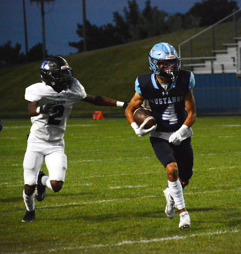 Ralston Valley senior Anthony Benallo (4) breaks away from Grandview junior Sir Robinson (2) during the first quarter Friday, Sept. 8, at the North Area Athletic Complex. Benallo had a spectacular touchdown grab before halftime to put the Mustangs up 17-0.