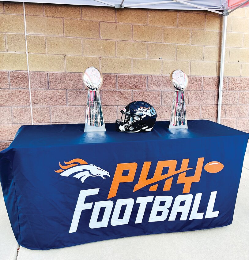 Two of the Lombardi Trophies from the Denver Broncos' three Super Bowl wins are displayed at Elizabeth High School on Sept. 1. The attendant on hand for the Denver Broncos High School Home Game of the Week event said the trophies are made of sterling silver.