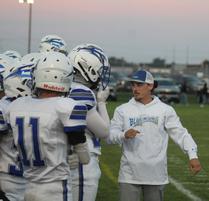 Fort Lupton assistant coach RJ Ramirez, talks to some of the Bluedevils' players during the first half of their team's win against Valley High School on Sept. 15