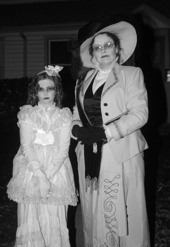 Two volunteer actors pose in costume at the Haunts of Littleton ghost tour.