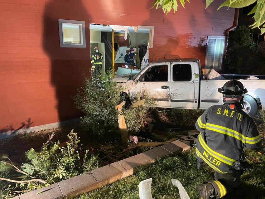 A South Metro Rescue fireman assess the damage done to a residential home after a vehicle crashed through the side of the home. The incident took place near the intersection of Grace Boulevard and Fairview Parkway, across the street from Valor Christian High School. Credit: Courtesy of the Douglas County Sheriff's Department